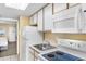 Efficient kitchen with white appliances, cabinets, and countertops near the bedroom at 2000 Ocean Blvd. N # Ph12, Myrtle Beach, SC 29577