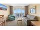 Cozy living room with comfortable seating and sliding glass doors to an ocean view balcony at 2000 Ocean Blvd. N # Ph12, Myrtle Beach, SC 29577