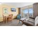 The stylish living room offers access to a balcony with ocean views, dining area and comfortable seating at 2000 Ocean Blvd. N # Ph12, Myrtle Beach, SC 29577