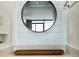 Close-up of modern bathroom vanity with shiplap details, a round mirror, and quartz countertop at 201 74Th Ave. N # 2638, Myrtle Beach, SC 29572