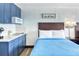 Comfortable hotel bedroom featuring a kitchenette and a blue bed with a dark wood headboard at 201 74Th Ave. N # 2638, Myrtle Beach, SC 29572