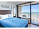 Comfortable hotel bedroom with a blue bedspread and a balcony overlooking the beach at 201 74Th Ave. N # 2638, Myrtle Beach, SC 29572