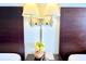 A bedside table with a lamp, a telephone, and a flower arrangement sits between two beds at 201 74Th Ave. N # 2638, Myrtle Beach, SC 29572