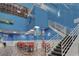 Lobby area with a staircase and a dining area in front of indoor pool, creating a vibrant and inviting space at 201 74Th Ave. N # 2638, Myrtle Beach, SC 29572