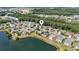 Beautiful aerial view of homes along a lake in a scenic neighborhood with mature trees at 205 Carriage Lake Dr., Little River, SC 29566