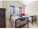 Cozy bedroom featuring two twin beds, soft carpet, and a bright window at 205 Carriage Lake Dr., Little River, SC 29566