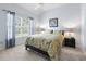 Serene bedroom with a queen-sized bed, soft lighting, and a view of the outdoors at 205 Carriage Lake Dr., Little River, SC 29566