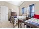 Comfortable bedroom with twin beds, soft carpet, and ample natural light from the window at 205 Carriage Lake Dr., Little River, SC 29566