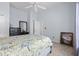 Bright bedroom featuring a queen bed, neutral walls, and an open closet at 205 Carriage Lake Dr., Little River, SC 29566