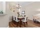 Bright dining room features a glass table, chandelier, and decorative plates on the wall at 205 Carriage Lake Dr., Little River, SC 29566