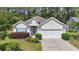 Charming one-story home with manicured lawn, two-car garage, and beautiful landscaping at 205 Carriage Lake Dr., Little River, SC 29566