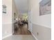 Inviting hallway leading to a bright living area with hardwood floors and neutral decor at 205 Carriage Lake Dr., Little River, SC 29566