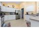 Traditional kitchen featuring white cabinets and stainless steel appliances at 205 Carriage Lake Dr., Little River, SC 29566