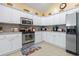 Kitchen with stainless steel appliances, white cabinets, and neutral countertops at 205 Carriage Lake Dr., Little River, SC 29566