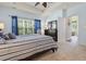 Main bedroom with carpet, dresser, ceiling fan, and a view to the outdoors at 205 Carriage Lake Dr., Little River, SC 29566