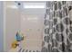 Shower and tub combo with tiled shower walls and decorative shower curtain at 205 Carriage Lake Dr., Little River, SC 29566