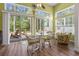 Sun room with lots of natural light, wood floors, a ceiling fan, and patio access at 205 Carriage Lake Dr., Little River, SC 29566