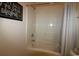 Clean bathroom with tile surround tub, shower curtain, and framed artwork at 2090 Cross Gate Blvd # 301, Myrtle Beach, SC 29575