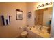 Well-lit bathroom with clean fixtures, framed art, and storage options at 2090 Cross Gate Blvd # 301, Myrtle Beach, SC 29575