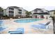 Community pool with plenty of lounge chairs for relaxing in the sun at 2090 Cross Gate Blvd # 301, Myrtle Beach, SC 29575