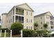 Exterior view of condo building with screened porches at 2090 Cross Gate Blvd # 301, Myrtle Beach, SC 29575