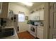 The cozy kitchen features white cabinets and appliances at 2090 Cross Gate Blvd # 301, Myrtle Beach, SC 29575