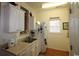 This kitchen features white cabinets, double basin sink, and neutral countertops at 2090 Cross Gate Blvd # 301, Myrtle Beach, SC 29575