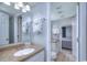 Well-lit bathroom featuring a granite countertop, ample cabinet space, and a view leading to the bedroom at 210 75Th Ave N # 4042, Myrtle Beach, SC 29572