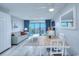 Comfortable living room and dining area features a sleeper sofa, balcony access, and coastal decor at 210 75Th Ave N # 4042, Myrtle Beach, SC 29572
