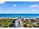 Stunning aerial view of oceanfront condo with blue water and white sandy beaches under a bright sky at 215 77Th Ave. N # 702, Myrtle Beach, SC 29572