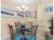 Cozy dining area with a round glass table and four chairs, adorned with coastal-themed decor at 215 77Th Ave. N # 702, Myrtle Beach, SC 29572
