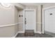 Condo entrance featuring a welcome mat, unit number, and a secured door with a modern handle at 215 77Th Ave. N # 702, Myrtle Beach, SC 29572
