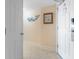 Hallway with tile flooring, a decorative whale hook, a framed print and a modern door with digital lock at 215 77Th Ave. N # 702, Myrtle Beach, SC 29572