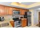 Kitchen with stainless steel appliances, wooden cabinets, and granite countertops for a modern look at 215 77Th Ave. N # 702, Myrtle Beach, SC 29572