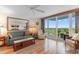 Bright living room with hardwood floors, comfortable seating, and access to a balcony with scenic views at 215 77Th Ave. N # 702, Myrtle Beach, SC 29572