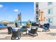 Relaxing outdoor patio features stylish seating, tables, and umbrellas with ocean view at 215 77Th Ave. N # 702, Myrtle Beach, SC 29572