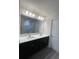 Bright bathroom with dual sinks, white quartz countertop, modern fixtures, and a glass-enclosed shower at 2247 Union Church Rd., Little River, SC 29566