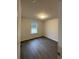 Bright bedroom with dark wood-look flooring and a window view to the outdoors at 2247 Union Church Rd., Little River, SC 29566
