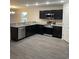 Modern kitchen boasts stainless steel appliances, granite countertops, and dark cabinetry at 2247 Union Church Rd., Little River, SC 29566