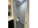 A clean toilet room with a toilet, small vanity, and door ajar for a peek into the well-lit space at 2247 Union Church Rd., Little River, SC 29566