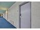 Condo hallway with blue carpet leading to the unit door at 2311 S Ocean Blvd. # 430, Myrtle Beach, SC 29577