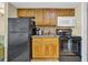 Kitchenette featuring black appliances and wooden cabinets at 2311 S Ocean Blvd. # 430, Myrtle Beach, SC 29577