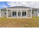 Backyard featuring a charming pergola and sliding glass doors, perfect for outdoor living at 247 Dempsey Dr., Loris, SC 29569