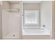 Bathroom featuring a luxurious bathtub, a separate shower, and a bright window for a serene experience at 247 Dempsey Dr., Loris, SC 29569