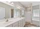 Bathroom featuring a double vanity, shower, and separate bathtub, offering a luxurious and convenient space at 247 Dempsey Dr., Loris, SC 29569