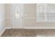 View of the home's entry door with decorative glass window and neutral walls at 247 Dempsey Dr., Loris, SC 29569