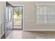 Bright foyer with hardwood floors and an open front door, providing a welcoming entrance to the home at 247 Dempsey Dr., Loris, SC 29569