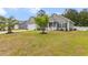 Lovely home with a cozy front porch, green lawn, and a two-car garage perfect for suburban living at 247 Dempsey Dr., Loris, SC 29569