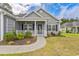 Inviting front porch with white railings and pillars, providing a welcoming entrance to the home at 247 Dempsey Dr., Loris, SC 29569