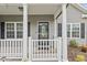 Close-up of a charming front porch with a decorative glass door, offering a glimpse of the home's curb appeal at 247 Dempsey Dr., Loris, SC 29569